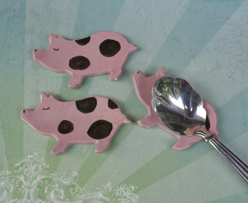 Pig ring holder. ONE Piglet teaspoon rest. Teaspoon rest. Coffee spoon rest. Chopstick rest. Teeny trinket dish. Pill holder.