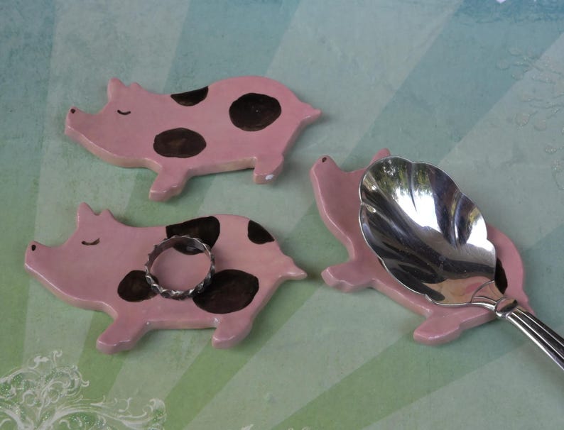 Pig ring holder. ONE Piglet teaspoon rest. Teaspoon rest. Coffee spoon rest. Chopstick rest. Teeny trinket dish. Pill holder.