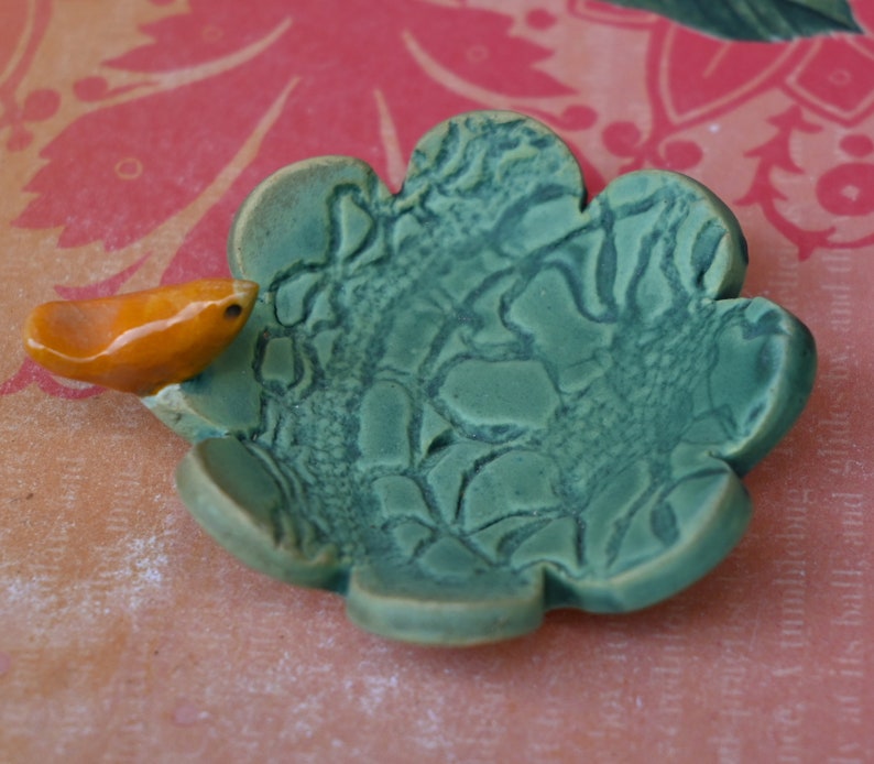 Teeny bird ring holder. Flower ring bowl. Teaspoon rest. Tea bag rest. Coffee spoon rest. Pill holder. Chopstick rest. Teeny trinket dish