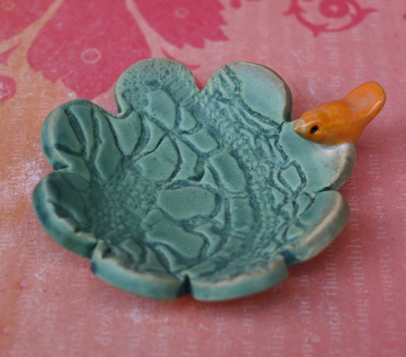 Teeny bird ring holder. Flower ring bowl. Teaspoon rest. Tea bag rest. Coffee spoon rest. Pill holder. Chopstick rest. Teeny trinket dish