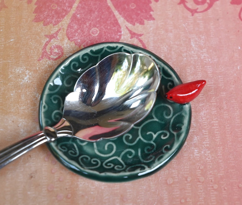 Red Cardinal ring holder. Tea bag rest. Teaspoon rest. Ring holder. Trinket dish. Chopstick rest. Tea light holder. Pill holder.