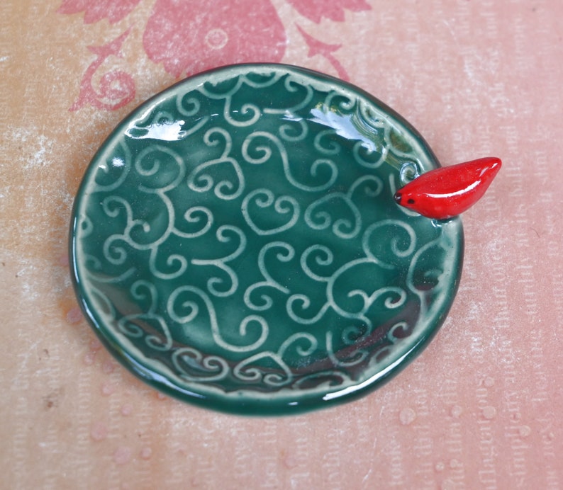 Red Cardinal ring holder. Tea bag rest. Teaspoon rest. Ring holder. Trinket dish. Chopstick rest. Tea light holder. Pill holder.