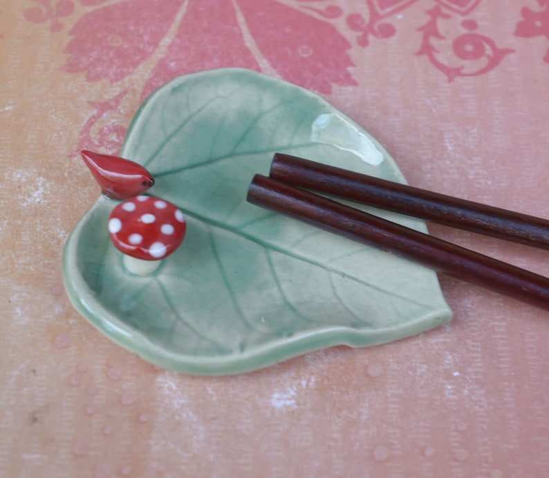 Leaf ring holder. Mushroom ring holder. Pill holder. Chopstick rest. Teaspoon rest. Red cardinal ring holder. Paint brush rest