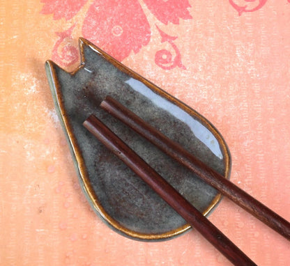 Cat ring holder. Teeny cat trinket dish. Teaspoon rest. Coffee spoon rest. Pill holder. Chop stick rest. Tea light holder. Knife holder